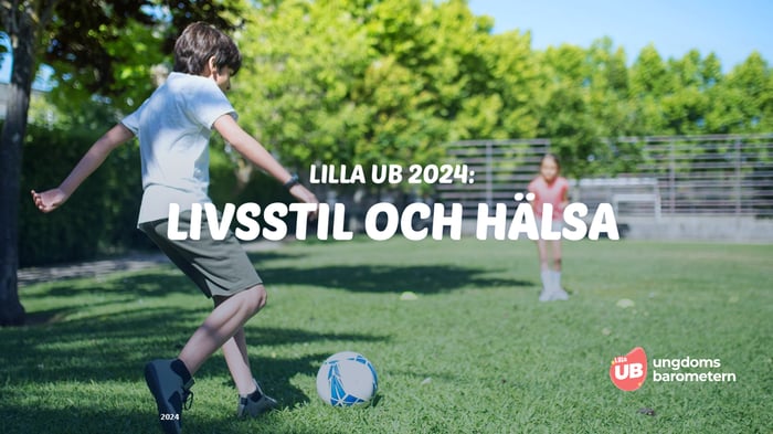 Barn som spelar fotboll på en gräsplan